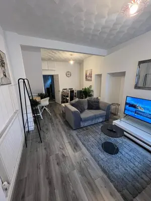 a living room with a couch and a tv at Anfield cosy stay in Liverpool