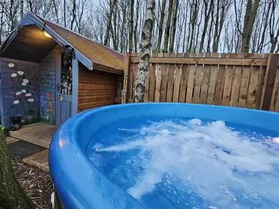 a large blue tub sitting in front of a fence at The Garden in Hambleton