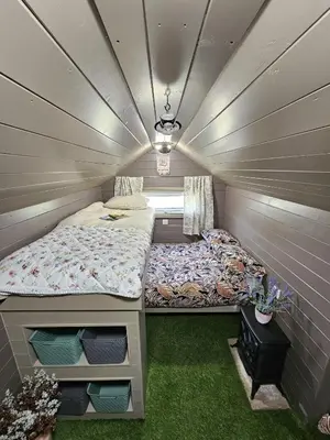 a small room with two beds in it at The Garden in Hambleton