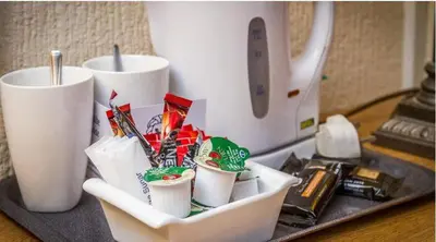 a tray with cups of food and a blender at Adelaide House Hotel - Opposite Winter Gardens, Town Centre in Blackpool