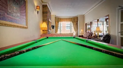 a living room with a pool table at Adelaide House Hotel - Opposite Winter Gardens, Town Centre in Blackpool