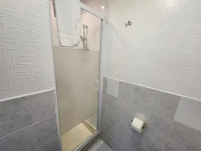 a shower with a glass door in a bathroom at The Everglades in Blackpool
