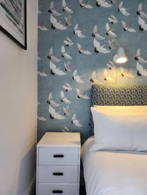 a bedroom with a bed and a wall with danes at The Everglades in Blackpool