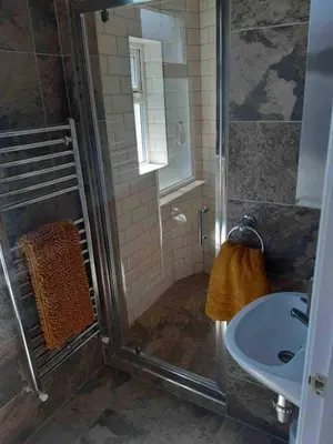 a bathroom with a shower and a sink at Ocean Suites HOT TUB - sleeps 11 in Blackpool