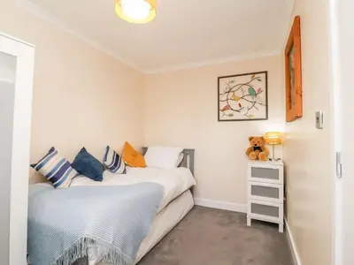 a bedroom with two beds and a teddy bear at Arnside House in Carnforth