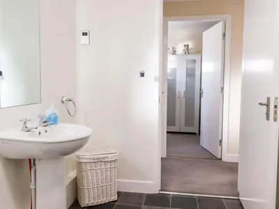 a bathroom with a sink and a mirror at Arnside House in Carnforth