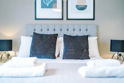 a bedroom with a bed with zebra pillows at Stunning Top-Floor 2BR Free Parking & Stylish Stay in Liverpool