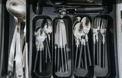 a bunch of utensils in a drawer with forks and spoons at Property is sold in Liverpool