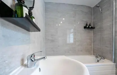 a bathroom with a white tub and a sink at Property is sold in Liverpool
