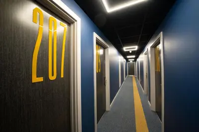 a long hallway with the number on the wall at URBAN HUB Student Accommodation in Preston