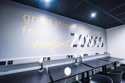 a wall with a sign that reads great things from corner zones at URBAN HUB Student Accommodation in Preston