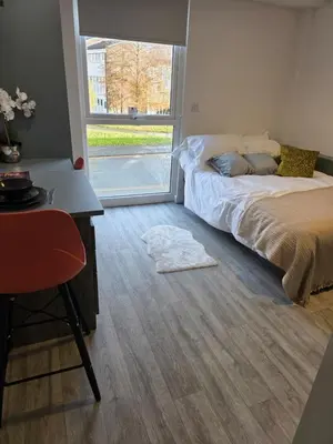 a bedroom with a bed and a desk and a window at URBAN HUB Student Accommodation in Preston