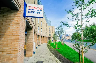 a tesco express sign on the side of a building at URBAN HUB Student Accommodation in Preston