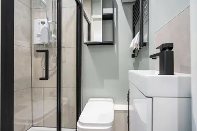 a bathroom with a shower with a toilet and a sink at Private Stay by Anfield Shared Kitchen Parking in Liverpool