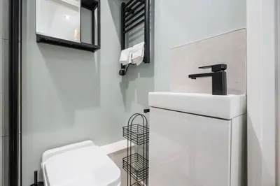 a white bathroom with a sink and a toilet at Private Stay by Anfield Shared Kitchen Parking in Liverpool