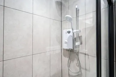 a shower with a blow dryer in a bathroom at Private Stay by Anfield Shared Kitchen Parking in Liverpool