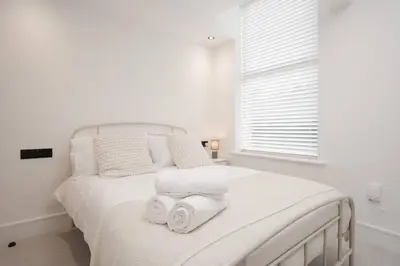 a bedroom with a white bed with towels on it at Private Stay by Anfield Shared Kitchen Parking in Liverpool