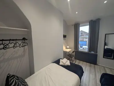 a bedroom with a bed and a window at 3Bed 2Bath house - Free Parking - Close to Everton & Liverpool FC- Managed by Chique Properties Ltd in Liverpool