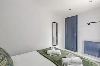 a living room with two white towels on a green rug at 3Bed 2Bath house - Free Parking - Close to Everton & Liverpool FC- Managed by Chique Properties Ltd in Liverpool