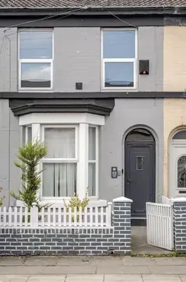 a house with a white fence and a black door at 3Bed 2Bath house - Free Parking - Close to Everton & Liverpool FC- Managed by Chique Properties Ltd in Liverpool