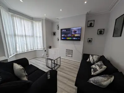 a living room with a couch and a flat screen tv at 3Bed 2Bath house - Free Parking - Close to Everton & Liverpool FC- Managed by Chique Properties Ltd in Liverpool