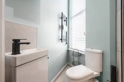 a bathroom with a white sink and a toilet at Work Desk Shared Kitchen Budget Parking in Liverpool