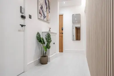 a hallway with a potted plant and a mirror at Work Desk Shared Kitchen Budget Parking in Liverpool