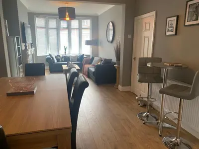 a living room with a table and a couch at Seaside Suites sleep 8 in Blackpool