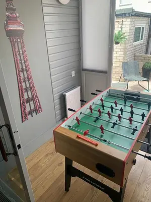 a foosball table in a living room with at Seaside Suites sleep 8 in Blackpool