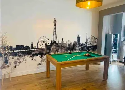 a room with a pool table in front of a wall at Seaside Suites sleep 8 in Blackpool
