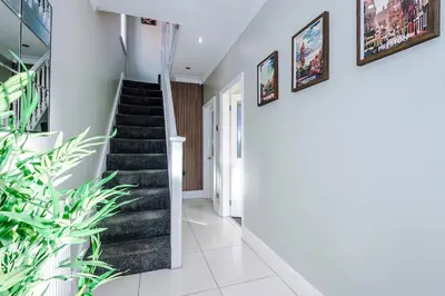 a staircase in a house with plants at 4 Bed House Relocators Trades and long stays in Samlesbury