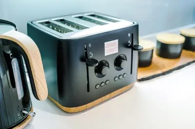 a black toaster sitting on top of a counter at 4 Bed House Relocators Trades and long stays in Samlesbury