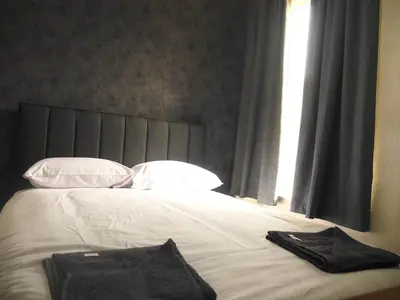 a bed with a black towel on top of it at The Stone House Hotel in Blackpool