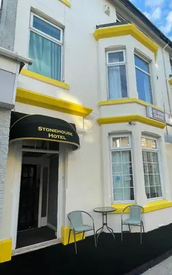 a table and chairs in front of a building at The Stone House Hotel in Blackpool