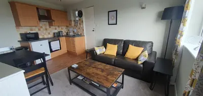 a living room with a couch and a table at Ivy's in Grange Over Sands
