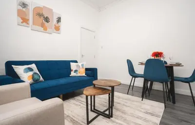 a living room with a blue couch and a table at Property is sold in Liverpool