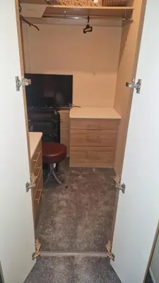 a closet with a desk and a chair in a room at Coastal Retreat Lodge in Morecambe