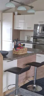 a kitchen with a counter with a basket of fruit at Coastal Retreat Lodge in Morecambe