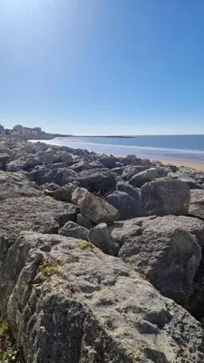 a group of rocks on a beach near the ocean at Coastal Retreat Lodge in Morecambe