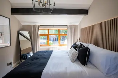a bedroom with a large bed with a large window at Rainbow Cottage Spacious Detached Home, Hot Tub, Sleeps 7 in Ormskirk
