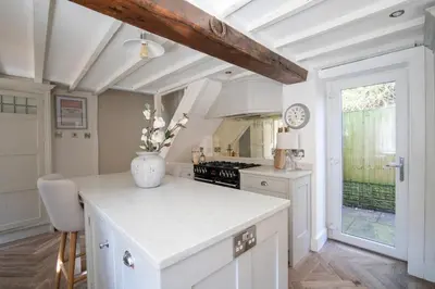 a kitchen with white cabinets and a white counter top at Rainbow Cottage Spacious Detached Home, Hot Tub, Sleeps 7 in Ormskirk