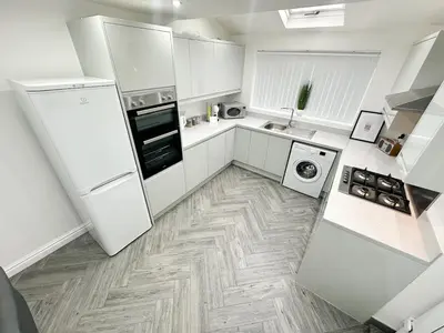 a white kitchen with a refrigerator and a dishwasher at Spacious Home, Central Liverpool, Sleeps 9, 2 Bathroom, Free Parking in Liverpool