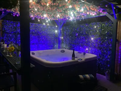 a bath tub in a room with purple lights at Tower Suites - HOT TUB sleeps 14 in Blackpool