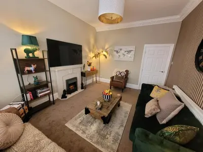 a living room with a couch and a fireplace at Tower Suites - HOT TUB sleeps 14 in Blackpool