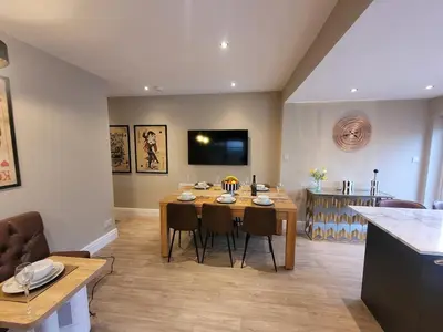 a kitchen and dining room with a table and chairs at Tower Suites - HOT TUB sleeps 14 in Blackpool