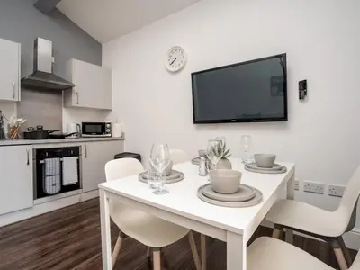 a white dining room with a white table and chairs at Flat 3, Colquitt St, 1 Bed, L1 - Pass the Keys in Liverpool