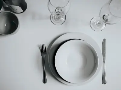 a white plate with a fork and knife on a table at Flat 1, Colquitt St, 1 Bed, L1 - Pass the Keys in Liverpool