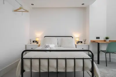 a bedroom with a bed with a desk and a chair at Private Kitchen & WM Work Desk Free Parking in Liverpool