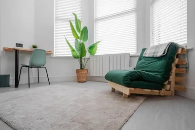 a living room with a green chair and a table at Private Kitchen & WM Work Desk Free Parking in Liverpool