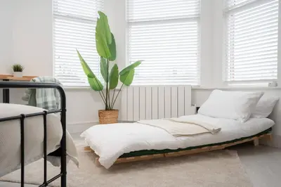 a bedroom with a bed and a potted plant at Private Kitchen & WM Work Desk Free Parking in Liverpool